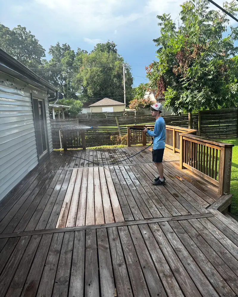 JB crew pressure washing a wood deck